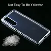 A clear phone case is shown on a black background, with a pile of small plastic pellets to the left. Produktbild-Vorschau
