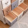 A close-up view of a wooden chest of drawers with several drawers open. Podgląd zdjęcia produktu