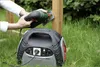 A person is using a jigsaw powered by a portable power station in a grassy outdoor setting. Podgląd zdjęcia produktu