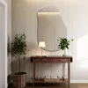 A modern entryway with a console table, a plant, and an abstract mirror. Produktbild-Vorschau