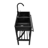 A black freestanding kitchen sink with a faucet on a white background. Produktbild-Vorschau
