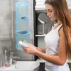 A woman is holding a tube of toothpaste in a bathroom setting, with a hanging storage organizer visible. Produktbild-Vorschau