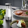 A salt grinder and a cake are on a kitchen counter. Podgląd zdjęcia produktu