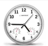 A round, white wall clock with a silver frame, displaying the time and two integrated gauges for temperature and humidity. Produktbild-Vorschau