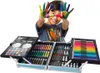 A young boy with colorful paint on his hands is smiling and holding his hands up in front of a large art set. Podgląd zdjęcia produktu
