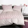 A neatly made bed with pillows and a duvet cover. Produktbild-Vorschau