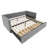 A gray upholstered sofa bed with a wooden slat mattress support and storage drawers underneath, shown from a slightly elevated side angle against a white background. Náhled obrázku produktu