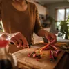 A person is chopping red chili peppers on a wooden cutting board in a kitchen. Podgląd zdjęcia produktu