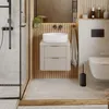 A modern bathroom with a wall-mounted vanity, sink, toilet, and shower. Náhled obrázku produktu