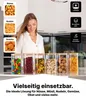 Sechs klare Glasaufbewahrungsgläser mit Bambusdeckeln, gefüllt mit verschiedenen Lebensmitteln, auf einer Küchenarbeitsplatte mit einer lächelnden Frau im Hintergrund Náhľad obrázku produktu