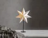 A star-shaped lamp on a stand, placed on a table with draped fabric and dried flowers. Podgląd zdjęcia produktu