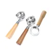 Three espresso portafilters with wooden handles are arranged on a white background. Náhled obrázku produktu