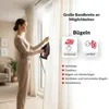 A woman is ironing a curtain with a steam iron, demonstrating different ironing methods. Produktbild-Vorschau