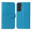A blue flip cover phone case with a floral and butterfly design is shown open, displaying the inside and the camera cutout area. Produktbild-Vorschau