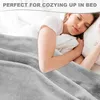 A woman sleeping comfortably under a soft gray blanket in bed. Produktbild-Vorschau