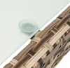 Close-up of a glass tabletop resting on a woven polyrattan frame. Produktbild-Vorschau