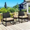 A three-piece polyrattan balcony set on a wooden deck with a view of trees and houses. Podgląd zdjęcia produktu