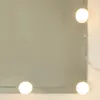 A close-up of a mirror with decorative lights around the edge. Voir les images du produit