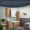A modern bathroom with wooden vanity, sink, mirror, and storage cabinets, decorated with plants. Produktbild-Vorschau