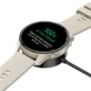 A smartwatch is shown charging on its dock. Náhled obrázku produktu