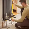A man is using a leveling tool and clamps to install a radiator. Náhľad obrázku produktu