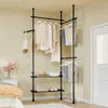 A corner of a bedroom with a clothing rack and some items on shelves. Podgląd zdjęcia produktu