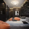 A modern bedroom with a bed, beanbag chair, and a unique ceiling light. Náhľad obrázku produktu