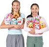 Two young girls are holding a collection of small plush toys, each with a candy bar or snack inside. Produktbild-Vorschau