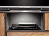 A close-up view of a modern media console shelf with a DVD player and a book. Náhľad obrázku produktu