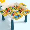 A children's building block table with storage bins filled with colorful blocks. Anteprima dell’immagine prodotto