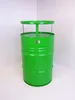 A bright green barrel-shaped table stands in a corner against a white wall. Podgląd zdjęcia produktu