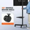 A person is holding a TV stand with wheels, and there is text highlighting its features. Produktbild-Vorschau