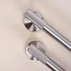 Two brushed steel bathroom handles are shown against a light beige background. Podgląd zdjęcia produktu