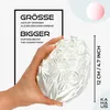A hand holding a decorative egg with a floral pattern, with text overlays highlighting its size. Voir les images du produit