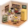 A miniature dollhouse kitchen scene with furniture and accessories. Podgląd zdjęcia produktu