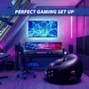 A modern gaming room setup with multiple monitors, a gaming chair, and an inflatable beanbag chair. Produktbild-Vorschau