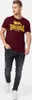 A man wearing a burgundy t-shirt with a yellow Lonsdale logo and dark wash jeans, standing against a white background. Produktbild-Vorschau