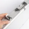 A close-up shot of a hand opening a latch on a silver aluminum case. Podgląd zdjęcia produktu