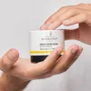 Hands holding a jar of Novexpert Extra Rich Repair Cream. Podgląd zdjęcia produktu