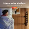 A person sleeping in bed next to a nightstand with a heater in the background. Produktbild-Vorschau