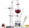 A laboratory distillation setup for essential oils, including glassware, a heating plate, and accessories, displayed against a white background. Produktbild-Vorschau