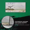 A wall clock with a beach landscape painting and a close-up detail of the canvas. Produktbild-Vorschau