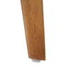 Close-up of the bottom of a wooden chair leg with a white protective cap. Produktbild-Vorschau