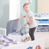 A young boy is interacting with a toy chest in a child's room. Produktbild-Vorschau