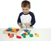 A young boy is playing with colorful wooden beads. Podgląd zdjęcia produktu