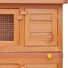 A close-up view of a wooden rabbit hutch, showing the doors and latches. Produktbild-Vorschau