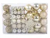 A clear, well-lit studio shot of a set of 100 gold and silver Christmas ornaments in a clear plastic box. Anteprima dell’immagine prodotto