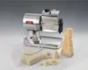 A stainless steel electric cheese grater with a block of cheese and grated cheese in a container. Podgląd zdjęcia produktu