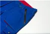 A close-up view of blue work pants with a red accent and a black zipper pocket. Produktbild-Vorschau