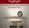 A nightstand with a glass, an alarm clock, and books, illuminated by integrated LED lighting. Voir les images du produit